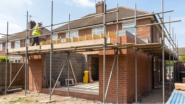 Brick single-storey extension under construction with scaffold