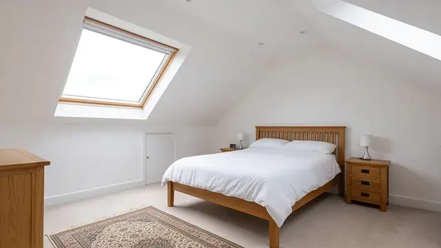 Finished loft conversion bedroom with a Velux rooflight window