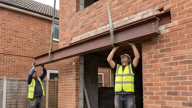 Steel RSJ beam being installed into a brick opening