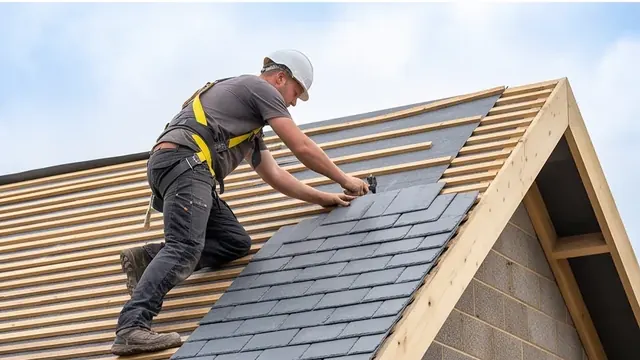 Roofer fitting tiles on a pitched roof