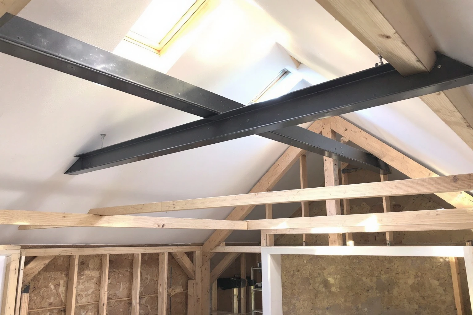 Structural steel beams installed at ceiling level — bungalow loft Newbury