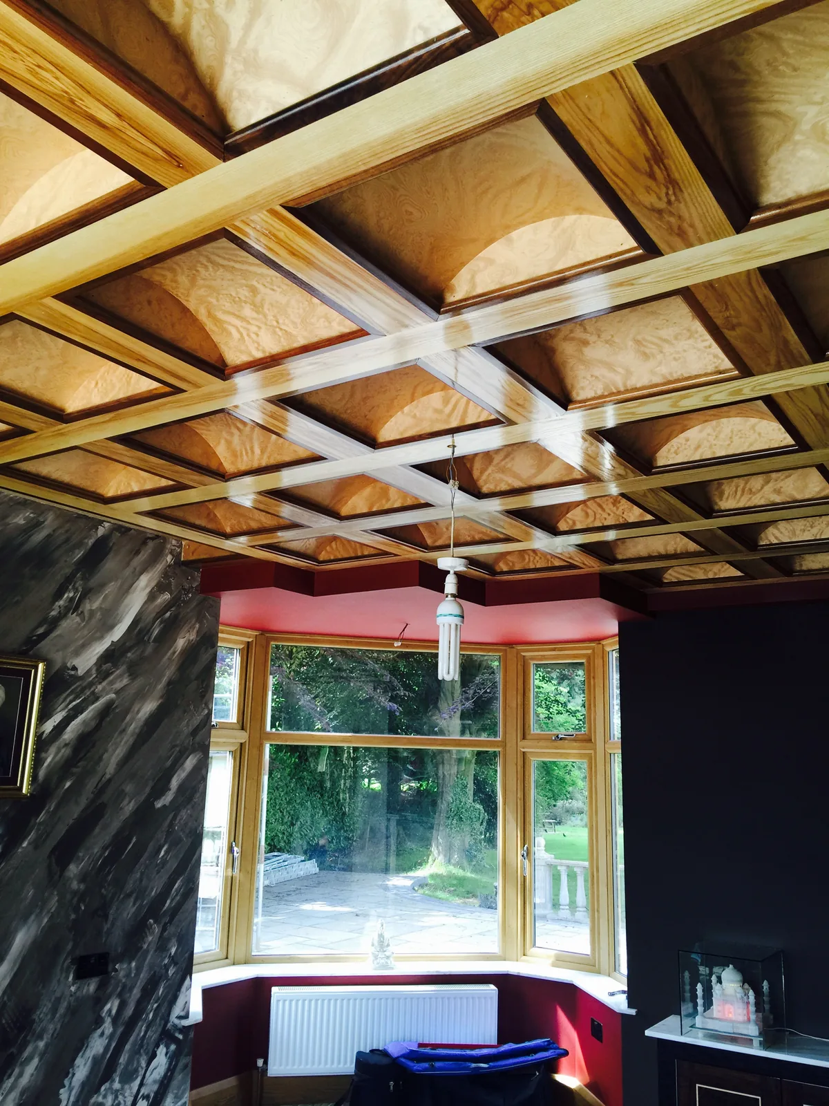 Hand-built coffered lounge ceiling in ash and walnut above a bay window, Sunningdale refurbishment