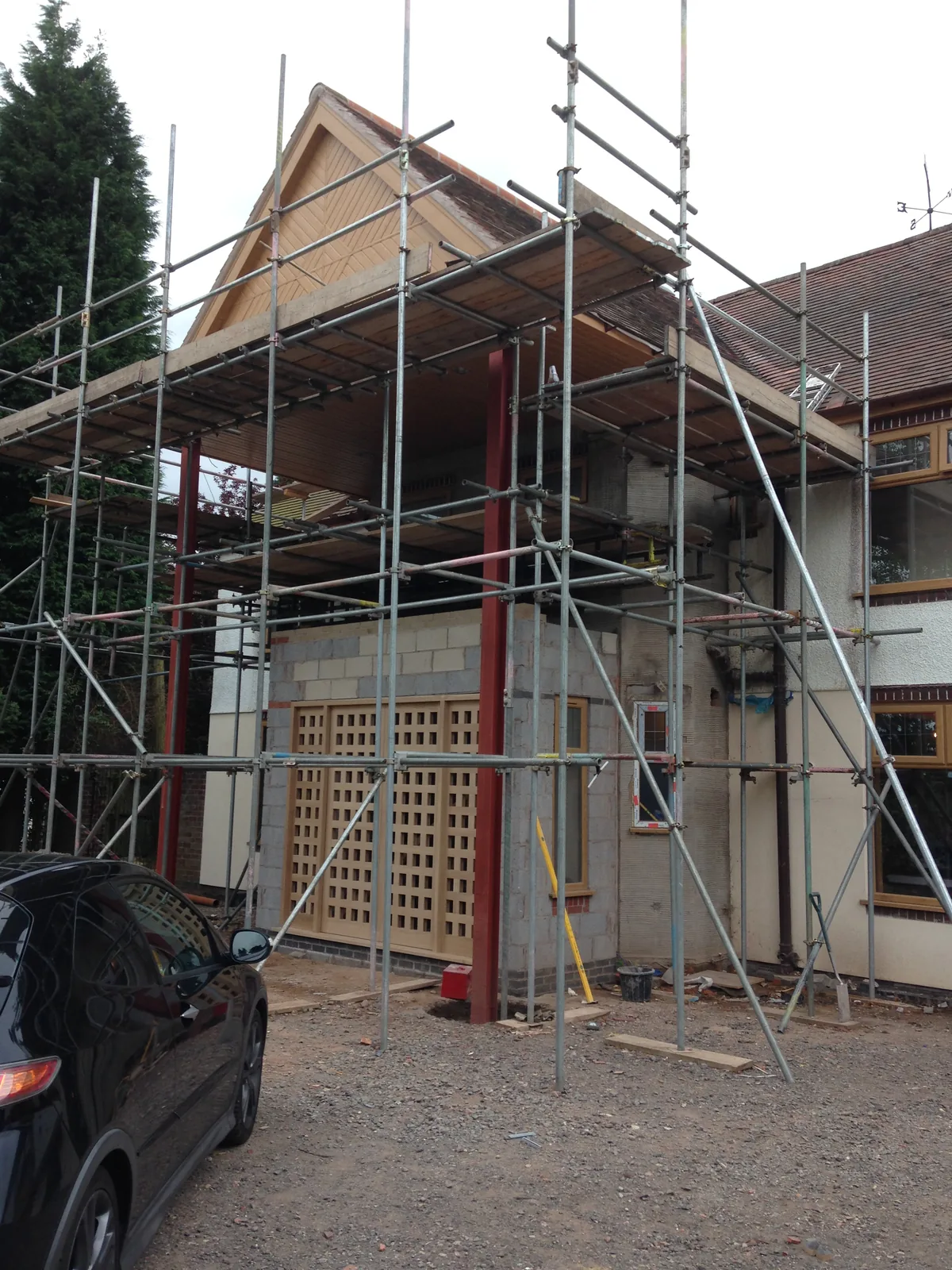 Structural steelwork and scaffold in place as the new granite-pillared porch extension takes shape, Sunningdale