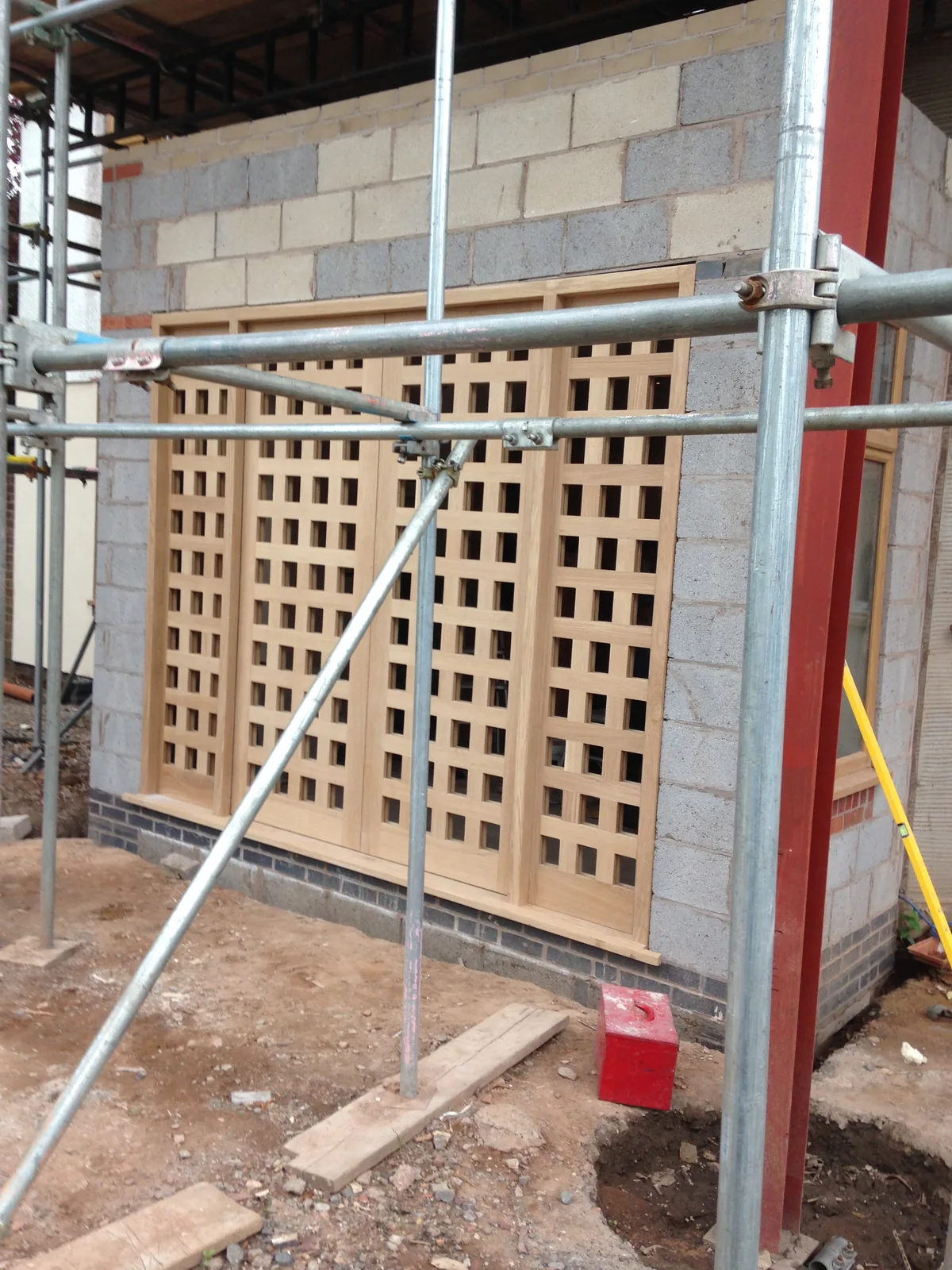 Bespoke oak lattice entrance doors under construction within the blockwork porch structure, Sunningdale
