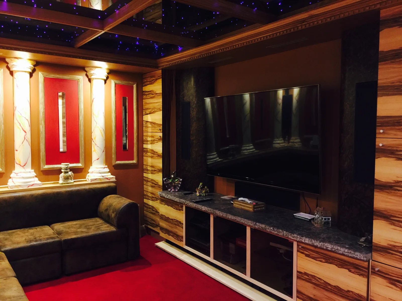 Completed home cinema room with marbled columns, starlight ceiling and reupholstered leather sofa, Sunningdale