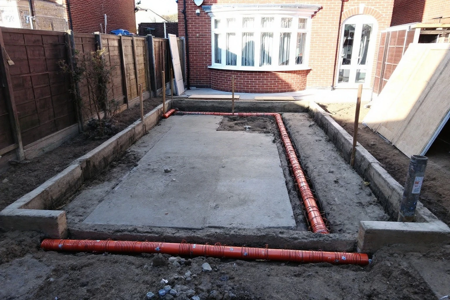 Strip foundations and drainage — rear extension Slough